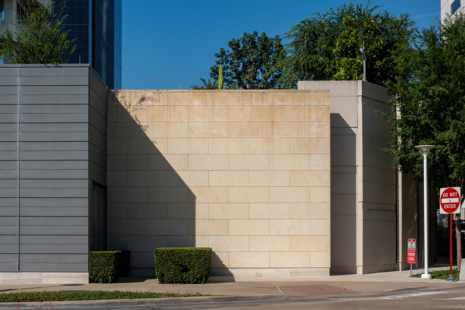 Modern commercial boundary wall with stone-effect architectural coating finish in Philippine urban development