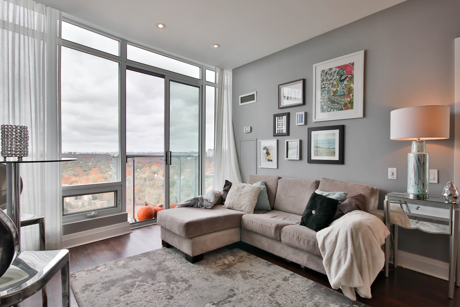 Modern luxury condo interior with seamless microcement flooring and polished feature wall in neutral tones